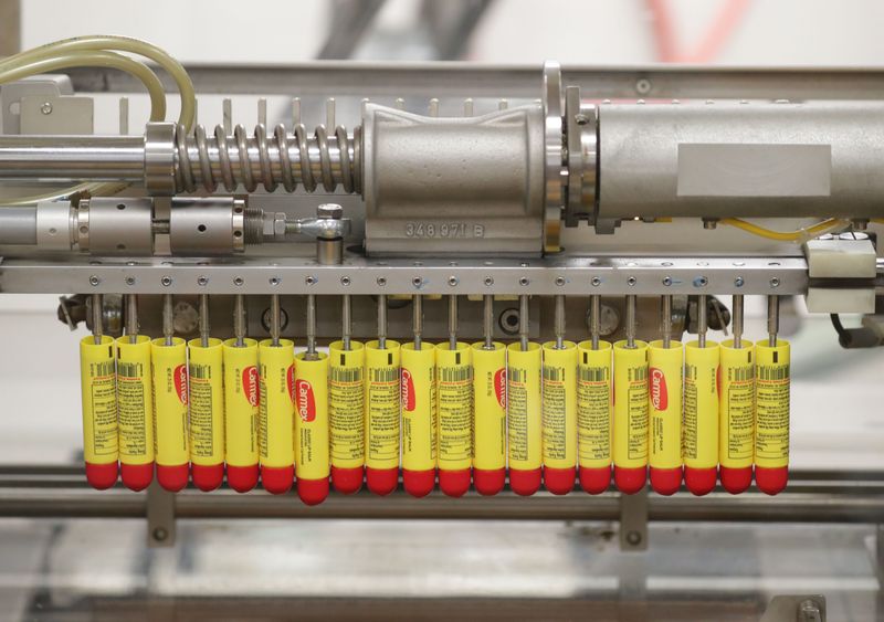 Tubes of Carmex move through the automated production process in the tube room at Carma Laboratories Inc. in Franklin.