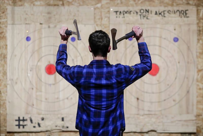 Ethan Markowski throws double axes April 9, 2019, during league night at Tapped on the Lakeshore in Two Rivers, Wis.