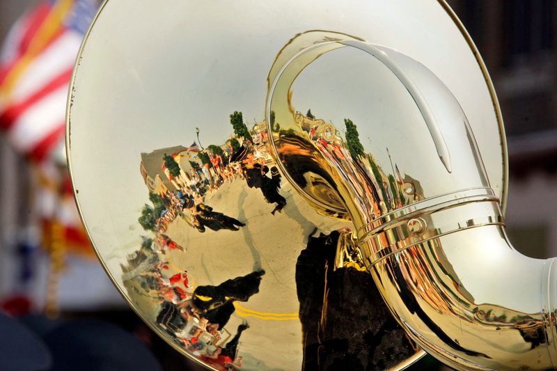 The Kiel Municipal Band is reflected in the bell of a sousaphone during the 2015 Independence Day Parade in Sheboygan.