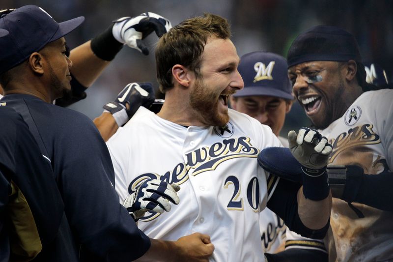 Milwaukee Brewers catcher Jonathan Lucroy is swarmed by teammates after hitting the game-winning run during the 10th inning against the Colorado Rockies in the regular-season opener Monday, April 1, 2013 at Miller Park in Milwaukee, Wis.
