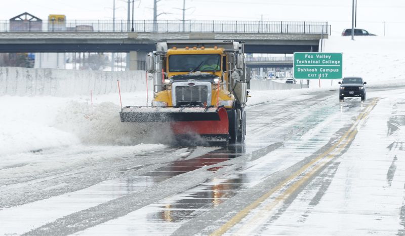 Oshkosh city streets crews were busy April 16, 2018, cleaning up after a spring storm dumped just over 11 inches of snow around the area, forcing many schools to close for the day.