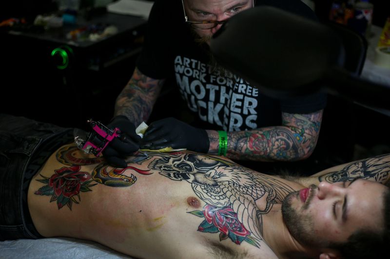 Brado Revell, Love and Devotion Historic Tattoo, tattoos Tyler Rado, from Elizabethtown, during the 8th Annual Louisville Tattoo Arts Convention put on by Villain Arts at the Kentucky Expo Center in Louisville, Ky. on Saturday, April 13, 2019.