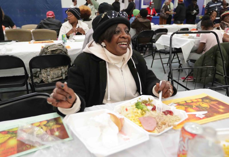 Jessie Gaines of Milwaukee is all smiles as she eats her Thanksgiving dinner at the King Community Center in 2019.
