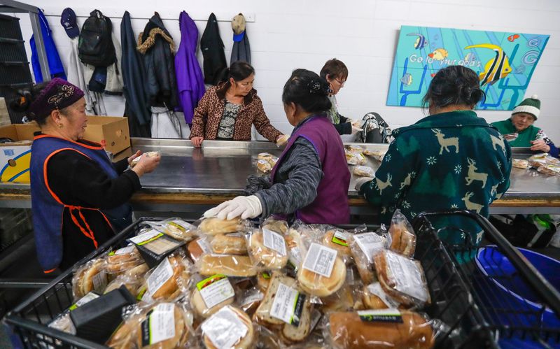 Paul's Pantry volunteers sort through sandwiches on Tuesday, March 17, 2020, at Paul's Pantry in Green Bay, Wis. Ebony Cox/USA TODAY NETWORK-Wisconsin