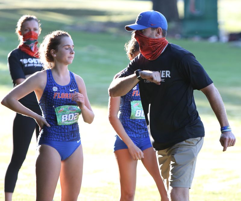 University of Florida distance coach Chris Solinsky talks with his runners before the women's race in the Mountain Dew Invitational cross country meet held at the Mark Bostic Golf Course at UF in Gainesville, Fla. Sept. 18, 2020. After almost six months without any athletic competitions due to the Covid-19 pandemic, University of Florida athletes got back to competition. The invitational meet is the first athletic competition for any UF athlete.