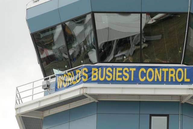 Air-traffic controllers and spotters at work in in the control tower at Wittman Regional Airport during EAA AirVenture 2012.