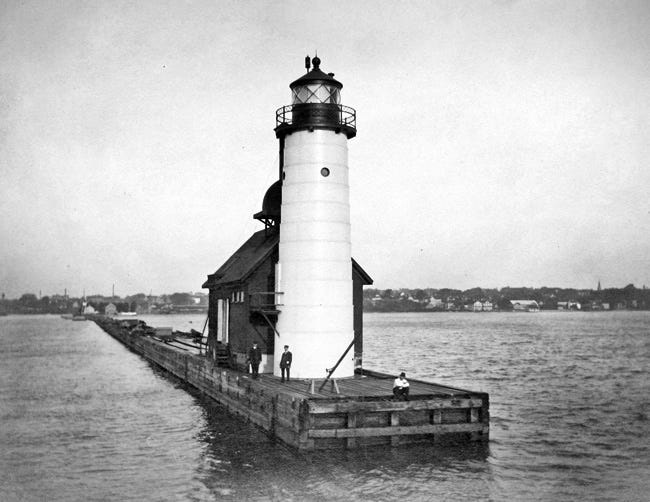 Before the current lighthouse was moved to a concrete pier in 1915, it resided, along with its fog house on a wooden pier. The structure was rebuilt and painted red when it was moved to the new concrete north pier.