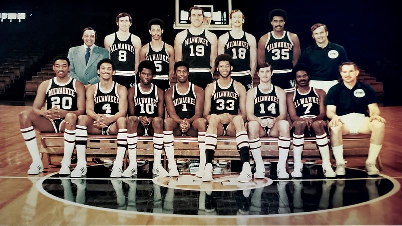 The 1970-’71 NBA champion Milwaukee Bucks: Seated, left to right: Bob Boozer, Greg Smith, Bob Dandridge, Oscar Robertson, Lew Alcindor, Jon McGlocklin, Lucius Allen, coach Larry Costello.  Standing, left to right: trainer Arnie Garber, Jeff Webb, Marvin Winkler, Dick Cunningham, Bob Greacen, McCoy McLemore, assistant coach Tom Nissalke.