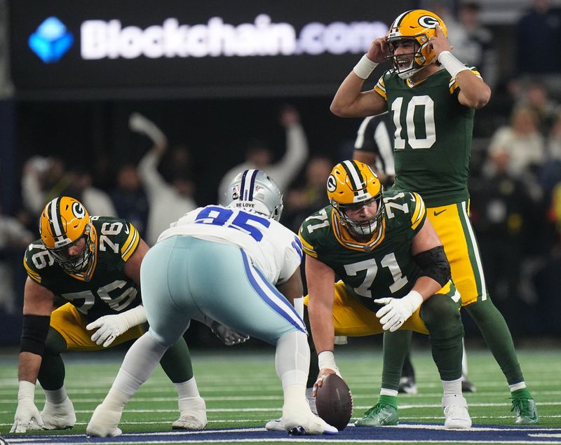 Green Bay Packers quarterback Jordan Love (10) makes an adjustment on the line during the first quarter of the wild card playoff game Sunday, Jan. 14, 2024, at AT&T Stadium in Arlington, Texas. The Green Bay Packers beat the Dallas Cowboys 48-32.