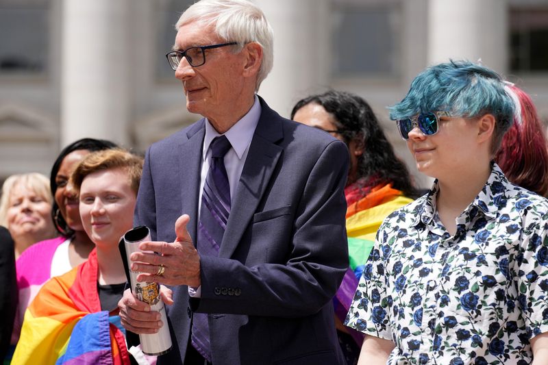 Gov. Tony Evers, left, stands next to 16-year-old Aspen Morris at the Rainbow Pride flag raising, June 1, 2022 at the Capitol in Madison. The symbol of lesbian, gay, bisexual and transgender pride will be flown over the Capitol’s East Wing in recognition of LGBTQ Pride Month, which runs until the end of June. In June 2019, Evers issued an executive order to raise the pride flag above the state Capitol for the first time in Wisconsin history. This is the fourth year the flag has flown below the U.S. and state flags on the east-wing flagpole.