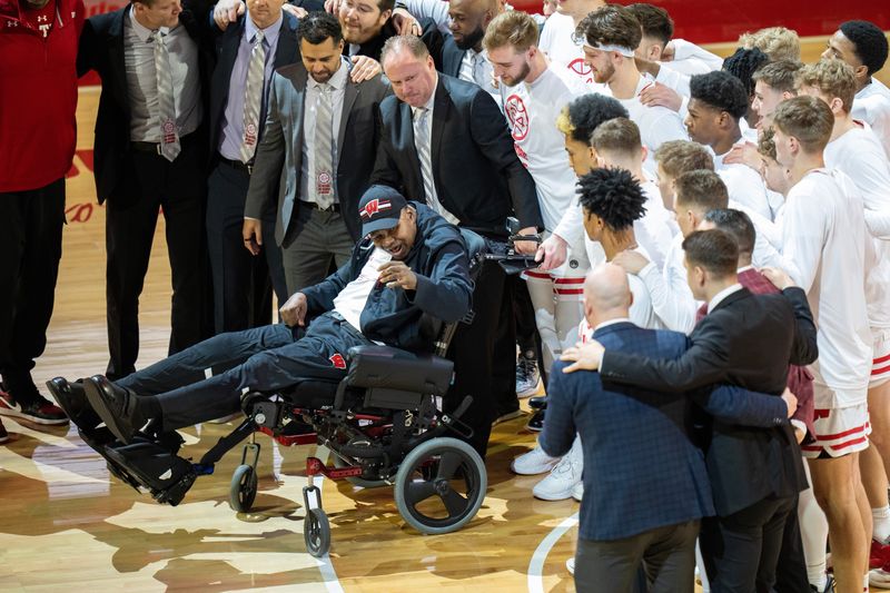 Former Wisconsin assistant coach Howard Moore, wheelchair, is honored before his former team’s game against Illinois, Saturday, March 2, 2024 at the Kohl Center in Madison, Wisconsin. Moore suffered severe burns in horrific automobile accident on Memorial Day weekend in 2020, resulting in the deaths of his wife and daughter. His son, Jerrell, suffered minor injuries.Mark Hoffman/Milwaukee Journal Sentinel