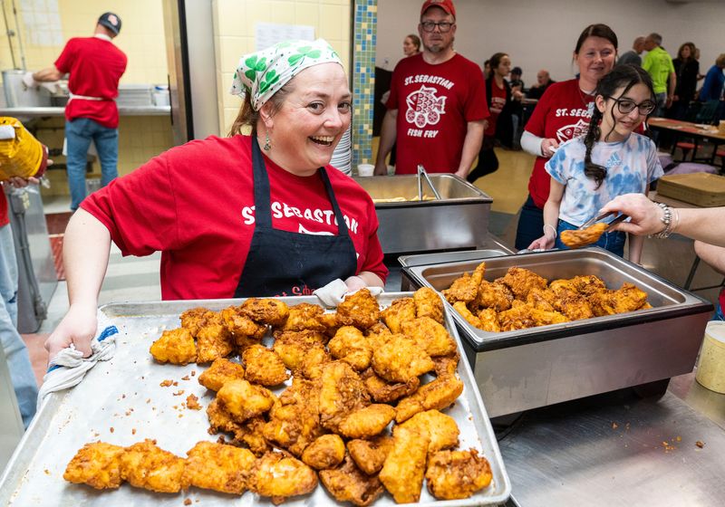 Lisa Weger, an organizer of the St. Sebastian Parish fish fry, wore a shamrock bandana for the March theme of St. Patrick's Day. She oversees the dining room throughout the evening.