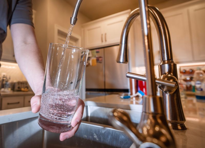 Tyler Frye fills a glass with water from a faucet that dispenses water processed with reverse osmosis Monday, February 5, 2024 in Casco, Wisconsin. The reverse osmosis greatly reduces the amount of nitrates in their water. Newlyweds Tyler and Shannon Frye recently bought their brand new house and discovered their well is contaminated with high levels of nitrates. The contaminated water is a problem for the entire Kewaunee County village which has no municipal water supply.

Mark Hoffman/Milwaukee Journal Sentinel