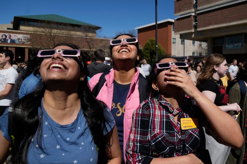 (From left to right) UWM masters students Reshma Dangeti, from Hyderabad India, Subhashini Thilakar-Chennai, from Tamil Nadu ,India and Meenakshi Anupindi, from Hyderabad, India watch the eclipse during a solar eclipse viewing party University of Wisconsin-Milwaukee in Milwaukee on Monday, April 8, 2024.