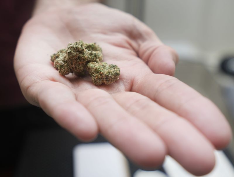 Darren Brook holds a hemp-derived product Thursday, March 28, 2024, at Barge Cannabis in West Bend, Wis. Ebony Cox / Milwaukee Journal Sentinel
