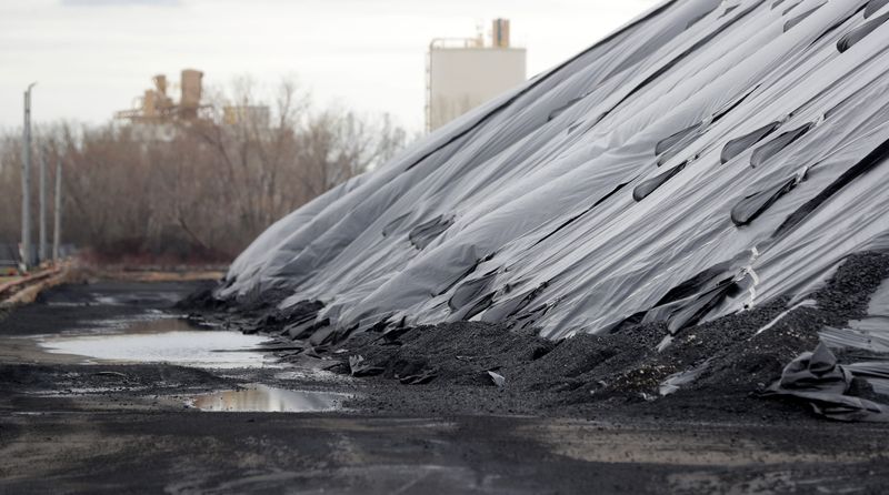 The coal piles at C. Reiss Coal Co. seen along the Fox River pictured on April 18, 2024, in Green Bay, Wis.