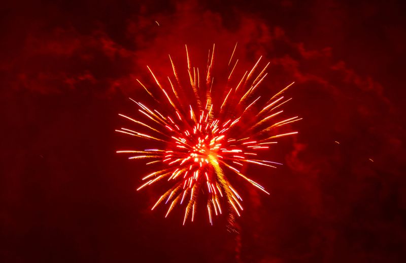 Wisconsin Rapids holds their annual Independence Day fireworks through the heavy rain over the Wisconsin River in Wisconsin Rapids, Wis. on Thursday, July 4, 2024. Spectators gathered closely under tarps, trees and umbrellas to avoid what rain they could while still finding which ever spaces they could in Veterans Memorial Park or on the West Grand Avenue Bridge to catch sight of the explosive show.