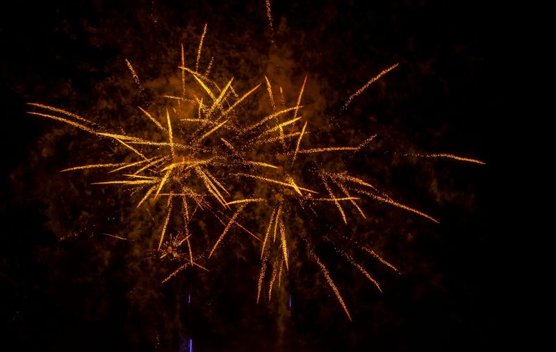 Wisconsin Rapids holds their annual Independence Day fireworks through the heavy rain over the Wisconsin River in Wisconsin Rapids, Wis. on Thursday, July 4, 2024. Spectators gathered closely under tarps, trees and umbrellas to avoid what rain they could while still finding which ever spaces they could in Veterans Memorial Park or on the West Grand Avenue Bridge to catch sight of the explosive show.