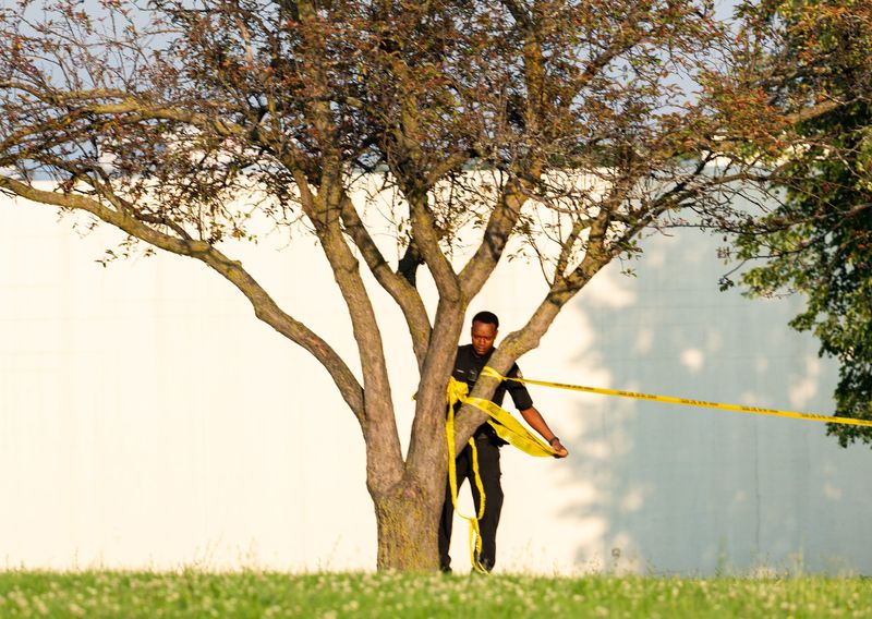 A police official is seen taking off police tape at King Park, near the site of the fatal shooting of Samuel Sharpe Jr., on Tuesday July 16, 2024 at King Park in Milwaukee, Wis.