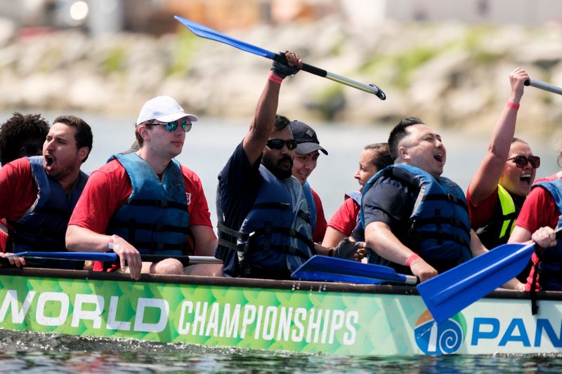 Dragon Boat racers celebrate a first place in the semifinals during the Milwaukee Dragon Boat Festival at Lakeshore State Park in Milwaukee on Saturday, Aug. 10, 2024. - Max Correa / Milwaukee Journal Sentinel