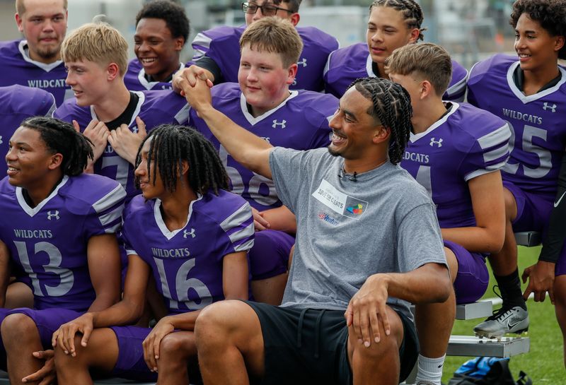 Green Bay Packers quarterback takes a picture with Green Bay West High School the football team on Monday, August 26, 2024, at Green Bay West High School in Green Bay, Wis. Love’s foundation, Hands of 10ve, is partnering with U.S. Venture to give youth football teams a set of new cleats for each touchdown Love runs or throws for in the 2024 season. Teams will be able to apply for cleats in December, and cleats will be given to teams based on need.