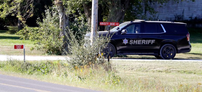 A county sheriff vehicle guards the entrance to a quarry along Kristy-Bob Lane during an investigation following a found body nearby, Monday, September 9, 2024, in Shoto, Wis.