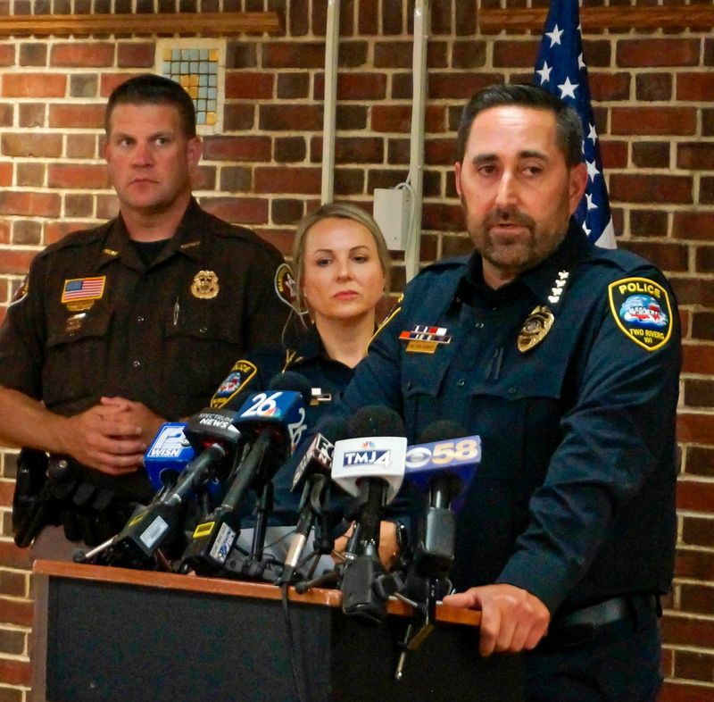 Two Rivers Police Chief Ben Meinnert, right, speaks at the podium with Assistant Chief Melissa Wiesner beside him, center, during a press conference, Friday, Sept. 13, 2024, at the Two Rivers J.E. Hamilton Community House where it was announced that the remains found near Shoto, Wisconsin, were those of Elijah Vue.