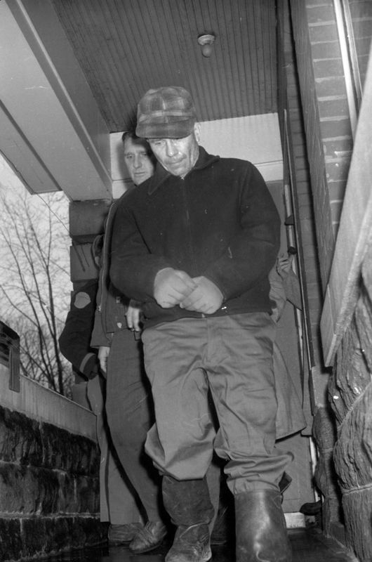 Ed Gein of Plainfield, Wisconsin, is followed by a guard as he's taken from the Waushara County Jail on Nov. 18, 1957. Gein had admitted killing Bernice Worden; more grisly details surfaced soon after.