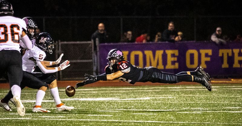 SPASH Panther junior defensive back and wide receiver Jonny Ananiadis (12) lunges for a pass in the first quarter of the conference game against the Marshfield Tigers at Goerke Field in Stevens Point, Wis. on Friday, Oct 18, 2024.