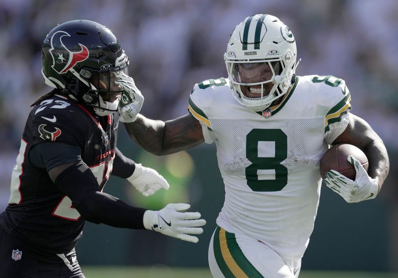 Green Bay Packers running back Josh Jacobs (8) stiff-arms Houston Texans safety Eric Murray (23) during the third quarter of their game Sunday, October 20, 2024 at Lambeau Field in Green Bay, Wisconsin.