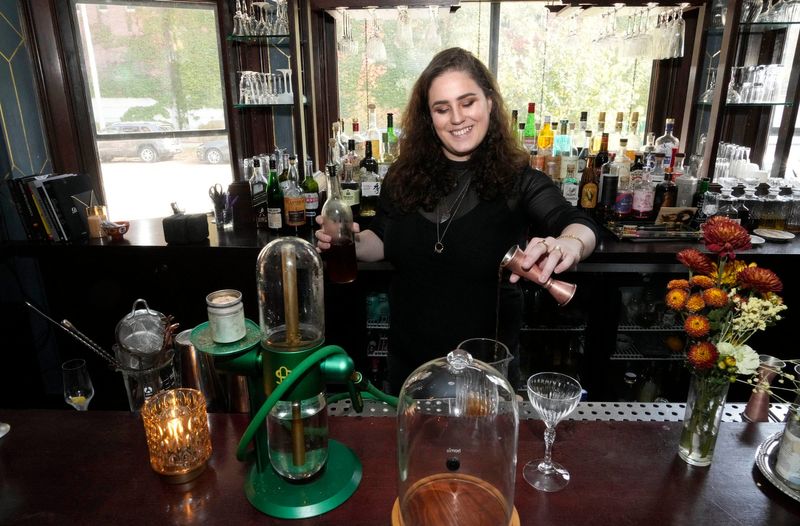 Kat Doughty, operating partner at Agency, makes a cocktail called Gravity’s Pull at the bar that's inside the Dubbel Dutch Hotel, 817 N. Marshall St., on Oct. 25, 2024. The Gravity’s Pull includes rye, bourbon, house nonalcoholic vermouth blend, All Day bitters and cherry bark vanilla bitters.