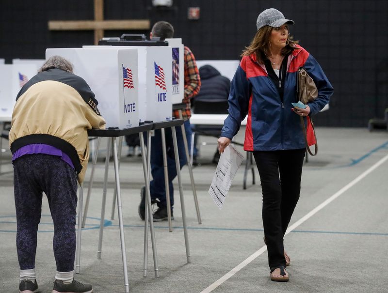 A voter goes to submit her ballot on Tuesday, November 5, 2024, at Green Bay Community Church in Howard, Wis. 
Tork Mason/USA TODAY NETWORK-Wisconsin