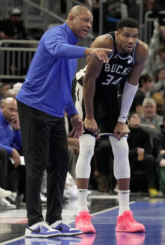 Milwaukee Bucks forward Giannis Antetokounmpo listens to coach Doc Rivers during a game against the Orlando Magic.