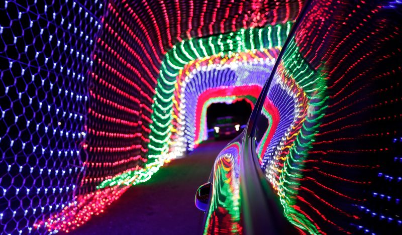 A vehicle goes through a light tunnel at the Holiday Lights on the Fox drive-thru display on Dec. 13, 2024, at the Brown County Fairgrounds in De Pere.