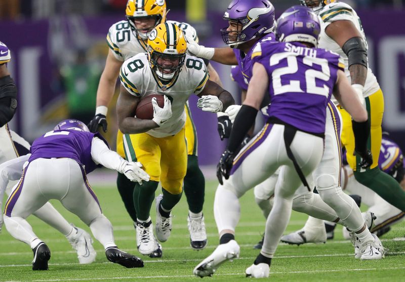 Minnesota Vikings cornerback Stephon Gilmore (2) forces a fumble by Green Bay Packers running back Josh Jacobs (8) in the first quarter during their football game Sunday, December 29, 2024, at U.S. Bank Stadium in Minneapolis, Minnesota.