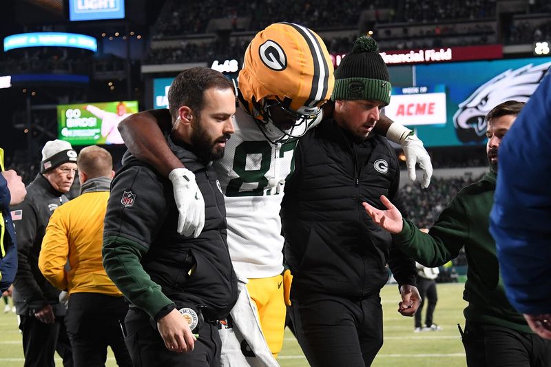 Green Bay Packers wide receiver Romeo Doubs is helped off the field after being injured against the Philadelphia Eagles in an NFC wild-card game.