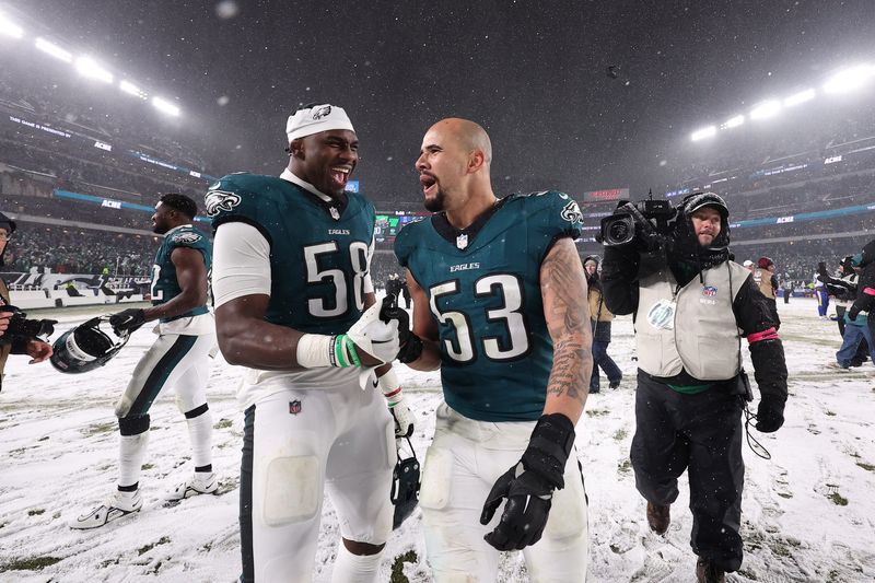 Jan 19, 2025; Philadelphia, Pennsylvania, USA; Philadelphia Eagles linebacker Jalyx Hunt (58) celebrates with Philadelphia Eagles linebacker Zack Baun (53) after defeating the Los Angeles Rams in a 2025 NFC divisional round game at Lincoln Financial Field. Mandatory Credit: Bill Streicher-Imagn Images