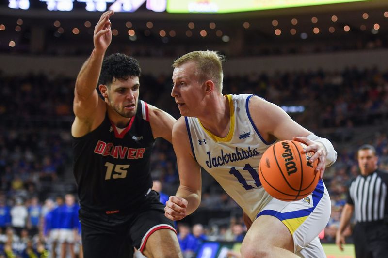 SDSU’s forward Matthew Mors (11) drives to the basket on Tuesday, March 12, 2024 at Denny Sanford Premier Center in Sioux Falls.