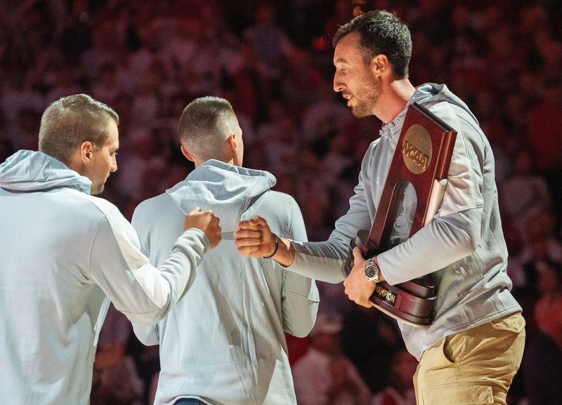 Former Wisconsin basketball player Frank Kaminsky, right, joins his former teammates on the court before the Wisconsin - Arizona game Friday, November 15, 2024 at the Kohl Center in Madison, Wisconsin. Wisconsin beat Arizona 103-88.
