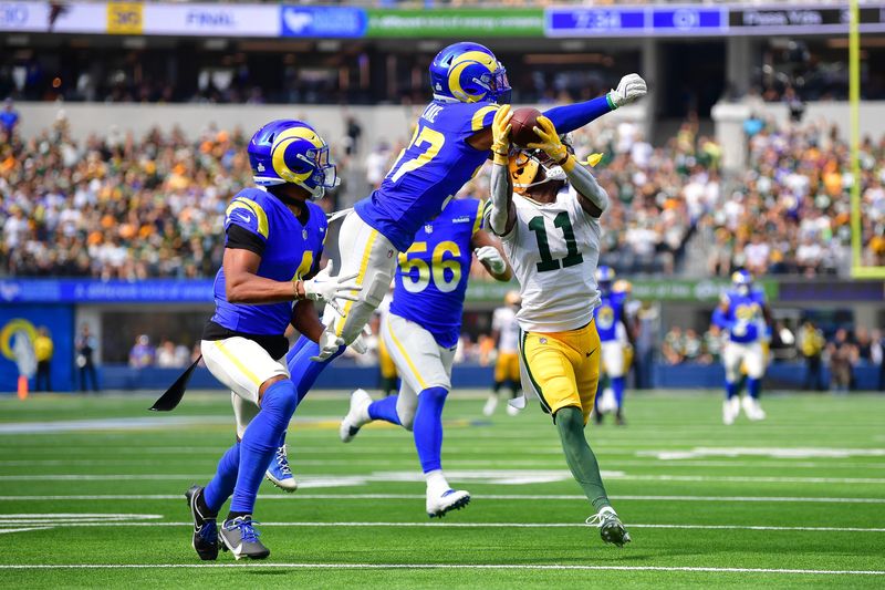 Oct 6, 2024; Inglewood, California, USA; Green Bay Packers wide receiver Jayden Reed (11) catches a pass against Los Angeles Rams safety Quentin Lake (37) during the first half at SoFi Stadium. Mandatory Credit: Gary A. Vasquez-Imagn Images