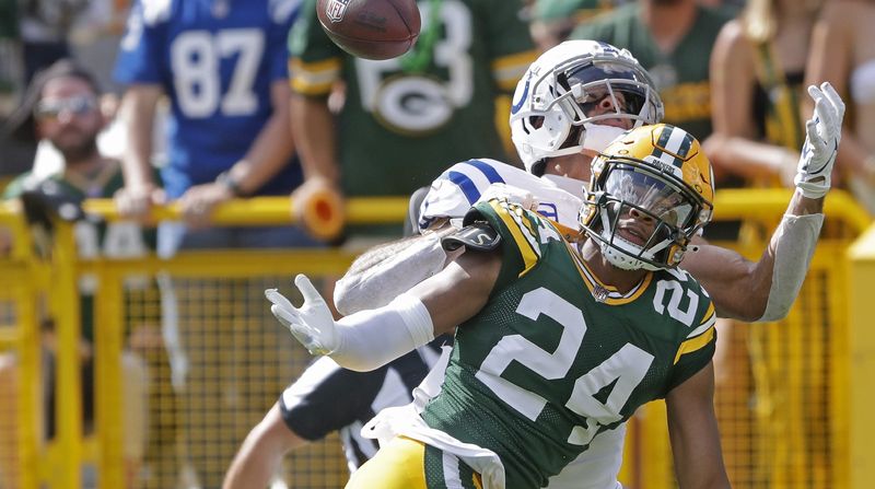Sep 15, 2024; Green Bay, Wisconsin, USA; Green Bay Packers cornerback Carrington Valentine (24) defends a pass in the end zone to Indianapolis Colts wide receiver Michael Pittman Jr. (11) at Lambeau Field. Mandatory Credit: Wm. Glasheen/USA TODAY Network via Imagn Images