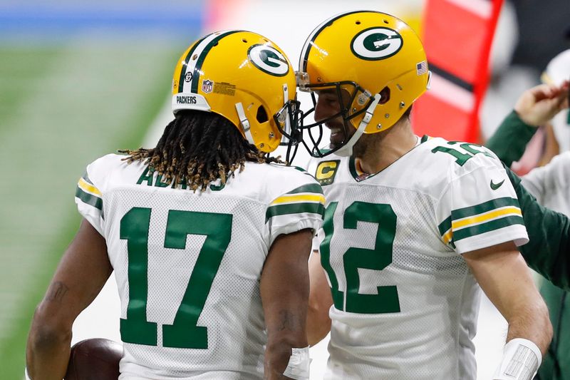 Dec 13, 2020; Detroit, Michigan, USA; Green Bay Packers wide receiver Davante Adams (17) celebrates with quarterback Aaron Rodgers (12) after a touchdown during the first quarter against the Detroit Lions at Ford Field. Mandatory Credit: Raj Mehta-USA TODAY Sports