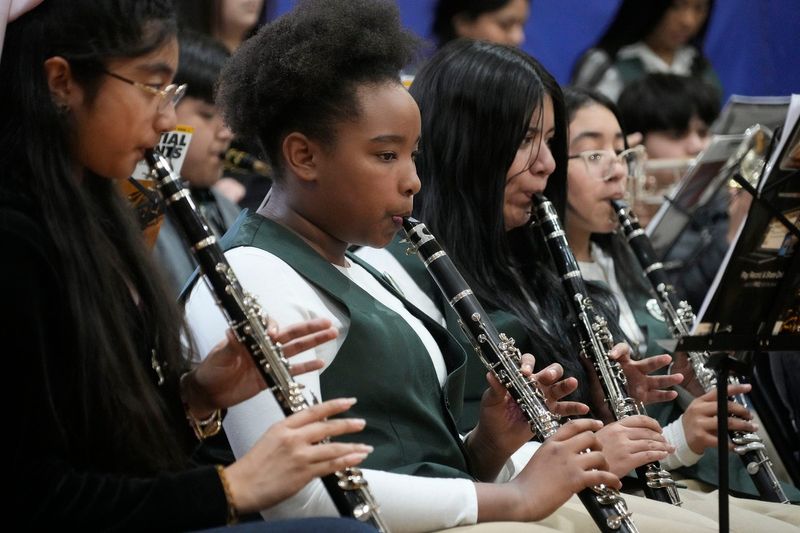 The Greenfield Bilingual band performs during an assembly at Greenfield Bilingual School in Milwaukee on Feb. 24, 2025. The Milwaukee Public School held a ribbon-cutting ceremony celebrating a new edition to the building including rooms for art and music instruction.