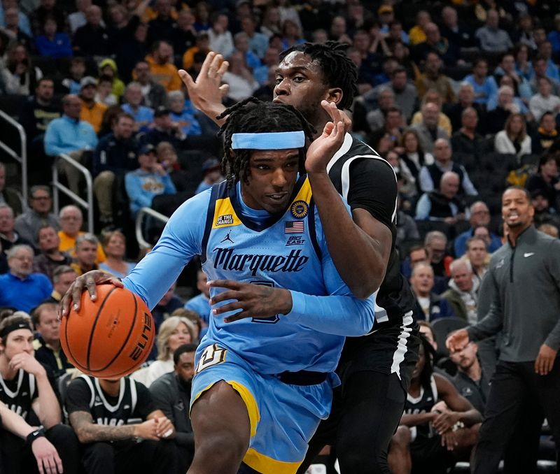 Marquette Golden Eagles guard Tre Norman (5) gets through Providence Friars forward Oswin Erhunmwunse (55) defense during the first half of the game on Tuesday February 25, 2025 at Fiserv Forum in Milwaukee, Wis.