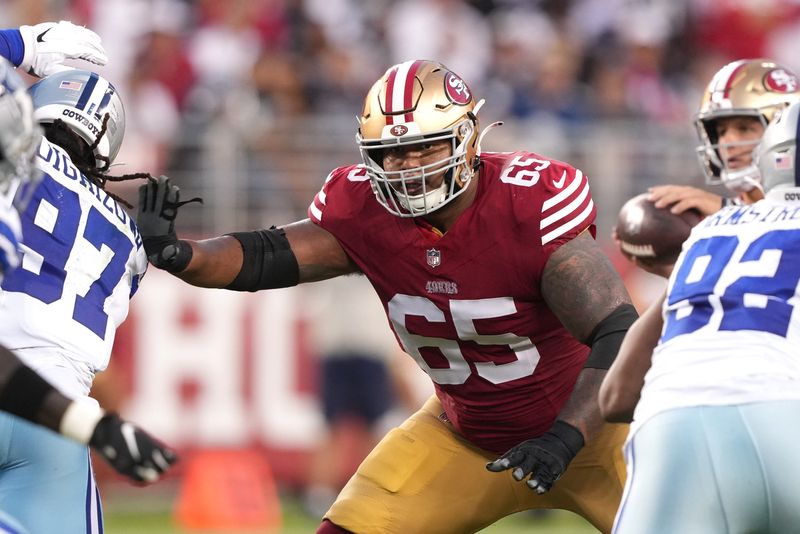Oct 8, 2023; Santa Clara, California, USA; San Francisco 49ers guard Aaron Banks (65) blocks against the Dallas Cowboys during the second quarter at Levi's Stadium. Mandatory Credit: Darren Yamashita-USA TODAY Sports