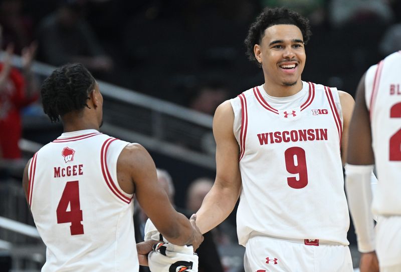 Mar 13, 2025; Indianapolis, IN, USA; Wisconsin Badgers guard Kamari McGee (4) high-fives Wisconsin Badgers guard John Tonje (9) during the second half at Gainbridge Fieldhouse. Mandatory Credit: Robert Goddin-Imagn Images