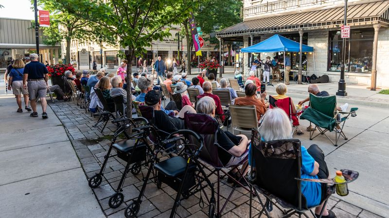 People enjoy live music in downtown Waukesha during Friday Night Live on August 2, 2024. Friday Night Live runs from June to September featuring multiple stages of entertainment and dozens of downtown businesses offering food, refreshments and shopping.