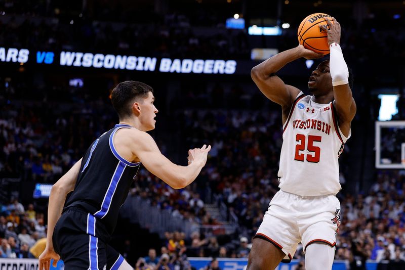 Mar 22, 2025; Denver, CO, USA; Wisconsin Badgers guard John Blackwell (25) shoots the ball against the Brigham Young Cougars during the first half in the second round of the NCAA Tournament at Ball Arena. Mandatory Credit: Isaiah J. Downing-Imagn Images