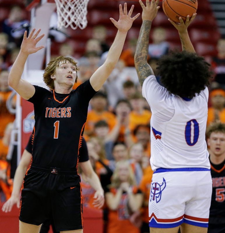 Marshfield High School's Chris Pohl (1) contests a shot by Wisconsin Lutheran High School's Alex Greene (0) during the WIAA Division 1 state championship game on Saturday, March 22, 2025, at the Kohl Center in Madison, Wis. 
Tork Mason/USA TODAY NETWORK-Wisconsin