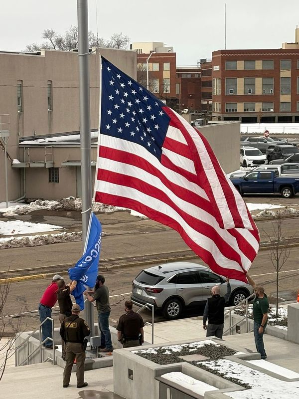 Wood County Sheriff's Office and Wood County Courthouse staff move the American and Wisconsin flags to the new Courthouse entrance Friday in anticipation of the county putting the new entrance to use on Monday.